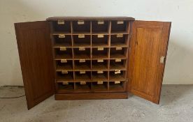 An oak postmaster pigeon hole sorting cupboard made up of twenty four sorting departments (H66cm
