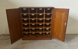 An oak postmaster pigeon hole sorting cupboard made up of twenty four sorting departments (H66cm