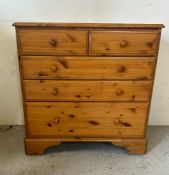 A Ducal two over three pine chest of drawers on castors with a gallery relief (H90cm W87cm D44cm)