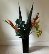Faux flowers in black tall vase