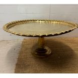 A brass engraved Middle Eastern tea table on brass engraved stand. Diameter 82 height 38