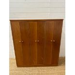 A Mid Century teak Clerical cabinet comprising of three cupboards and multiple shelves (H128cm
