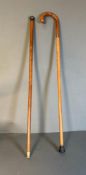 Two vintage walking sticks, one with a silver hallmarked handle and the other with a 9ct gold band
