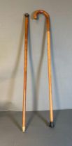 Two vintage walking sticks, one with a silver hallmarked handle and the other with a 9ct gold band