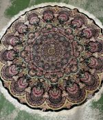 A circular silk rug with blue grounds and floral motif diameter 157