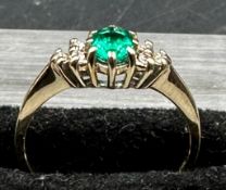 A 9ct gold ring with emerald and diamonds size M