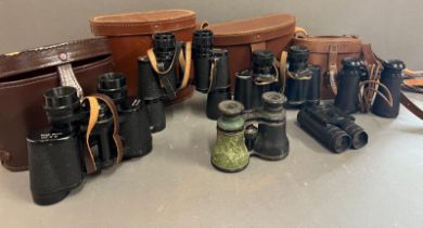 Nine pairs of binoculars, various sizes