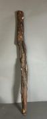 A Tribal carved club or staff with snakes and monkeys etc