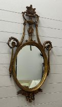 A neoclassical style oval giltwood mirror (H120cm W64cm)