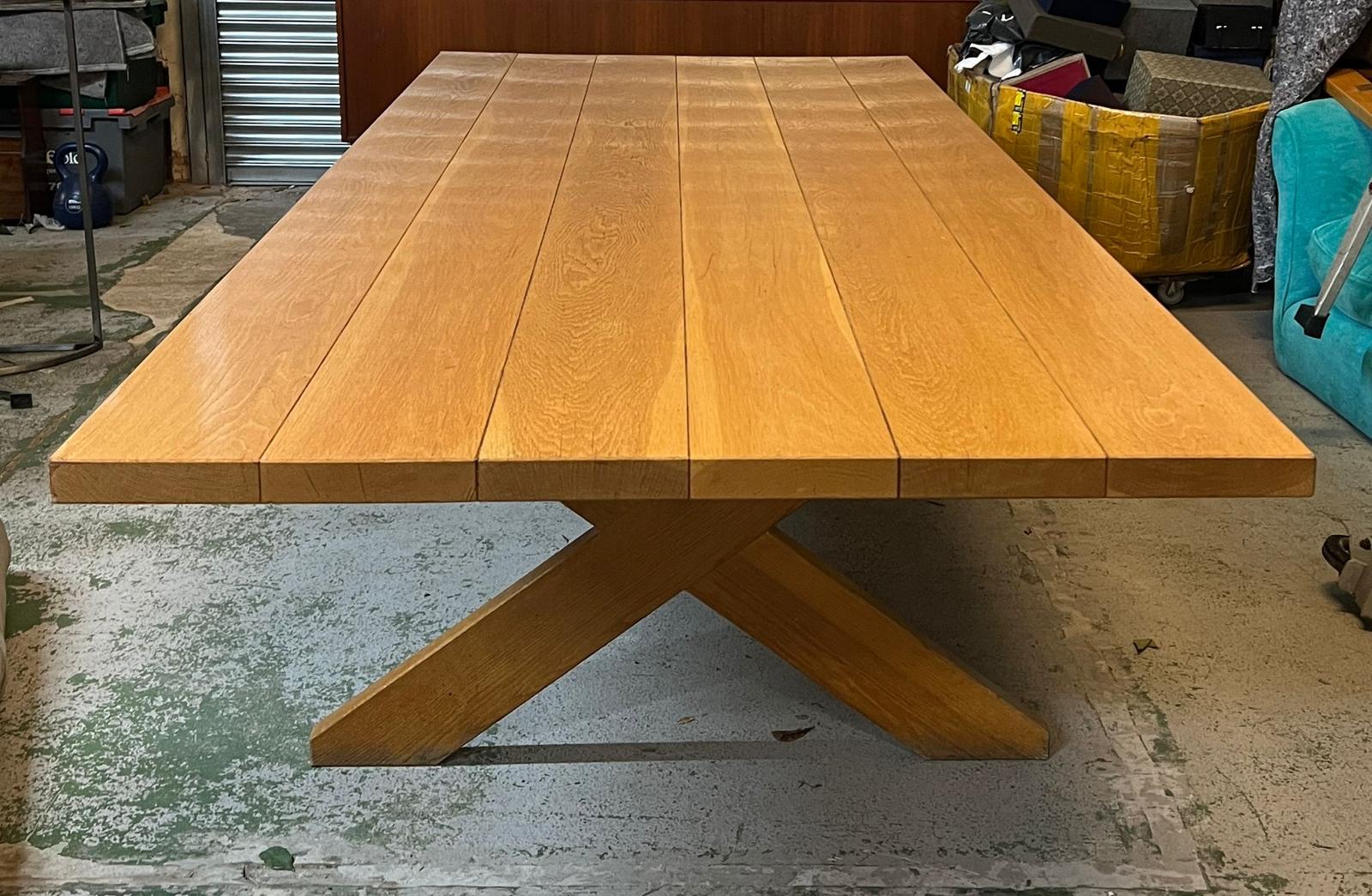 A large six plank light oak refectory table with X frame legs (H76cm W305cm D121cm)