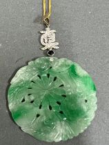A round Jade and Diamond Chinese pendant on 21ct gold necklace