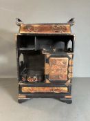 A Japanned jewellery box with drawers and cupboard opening to three small drawers 44.5cm H