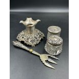 A selection of hallmarked items to include a stand, two silver topped jars and silver handled pickle