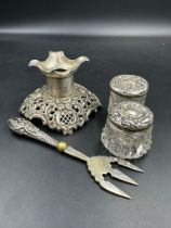 A selection of hallmarked items to include a stand, two silver topped jars and silver handled pickle