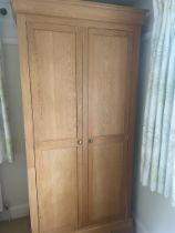 A light oak double wardrobe (H222cm W104cm D60cm)