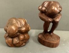 Two abstract wooden carvings of meditation women