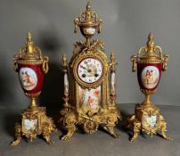 A French eight day hand painted enamel faced mantel clock with garniture