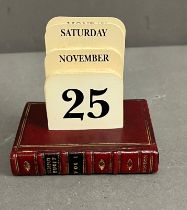 A perpetual desk calendar on a stand in the form of a book (8cm x 6cm)