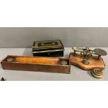A metal cashbox and a wooden desk pen holder with inkwells to end and a brass letter scales with