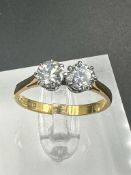 A double diamond engagement ring on yellow gold, marked 750.