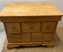A light oak chest of drawers (H79cm W101cm D63cm)