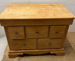 A light oak chest of drawers (H79cm W101cm D63cm)