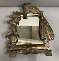 A metal dressing table mirror with peacock to one side (43cm x 35cm)