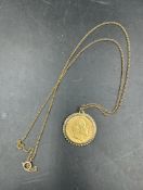 A 1906 Half Sovereign on 9ct gold mount and chain. (Approximate Total Weight 7.1g)