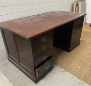 A mahogany pedestal desk with brown leather top and comprising of 3 drawers to right and four to