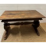 An oak Italian renaissence style hall table with peg end cross streacher and lions paw feet