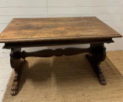 An oak Italian renaissence style hall table with peg end cross streacher and lions paw feet