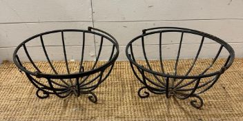 Two black wrought iron baskets possibly hanging baskets