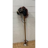 A vintage hobby horse with green floral face