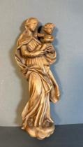A wooden carved wall hanging of the virgin mary with child