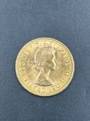A 1968 Gold sovereign coin.