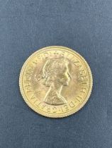 A 1968 Gold sovereign coin.