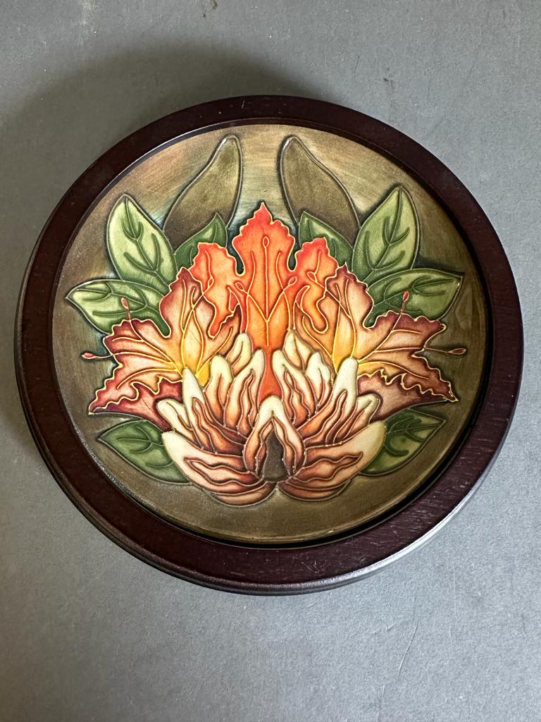 A Moorcroft plaque in the flame of the forest pattern