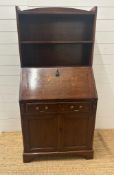 An oak bookcase bureau with single cupboard and single drawer and two shelf over (H157cm W74cm