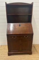 An oak bookcase bureau with single cupboard and single drawer and two shelf over (H157cm W74cm