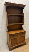 A kitchen dresser comprising of two shelves and two drawers and two cupboards under (H197cm W91cm