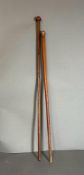 A brass topped swagger or walking stick along with an iron wood Zulu Knobkerrie