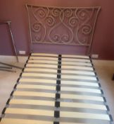 A metal bed frame with scrolling ends 4ft 6