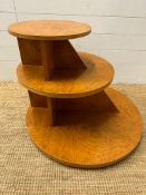 A French Art Deco style bur elm ,three tier table comprising of three graduated disks on flat