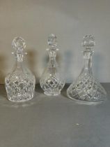 Three cut glass decanters