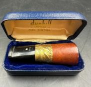 A boxed Dunhill cigar holder with 9ct gold band