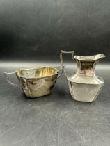 A silver milk jug and sugar bowl hallmarked for London 1894 by William Hutton & Sons Ltd approximate