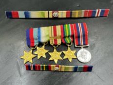 WWII Medal miniatures along with two medal bars. 1939-45 Star, The Atlantic Star, The Africa Star,