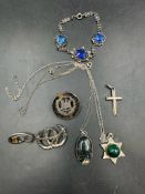 A selection of silver and white metal jewellery to include necklaces, bracelet and brooches