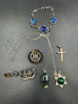 A selection of silver and white metal jewellery to include necklaces, bracelet and brooches