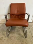 A 1970's office chair by Luxy with brown upholstery on chrome legs